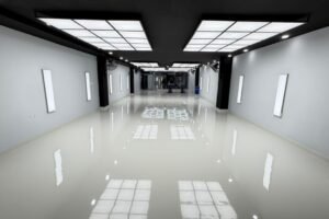professional car detailing studio main work bay illuminated by Newon Lighting hexagonal and 2x2 ft surface-mounted LED panels