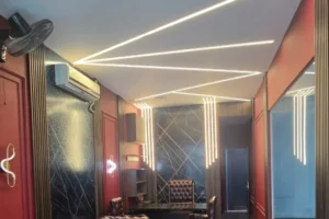 Zigzag recessed linear profile ceiling lighting in 3000K warm white installed by Newon in the Detailing Dungeon showroom lounge, Islamabad
