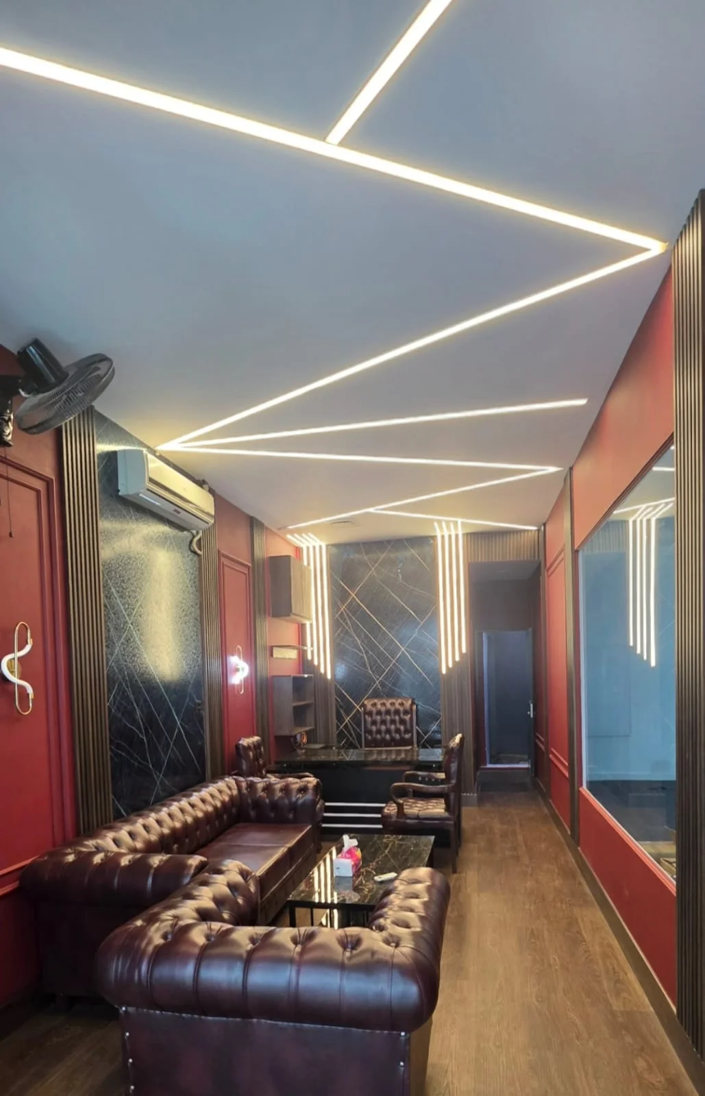 Zigzag recessed linear profile ceiling lighting in 3000K warm white installed by Newon in the Detailing Dungeon showroom lounge, Islamabad