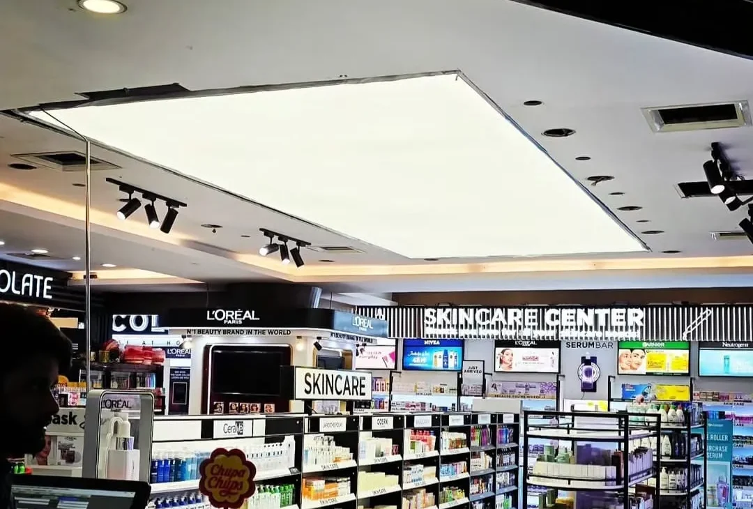 Finished 8x20 ft white plain backlit stretch fabric ceiling glowing uniformly over the Shaheen Cosmetics sales floor