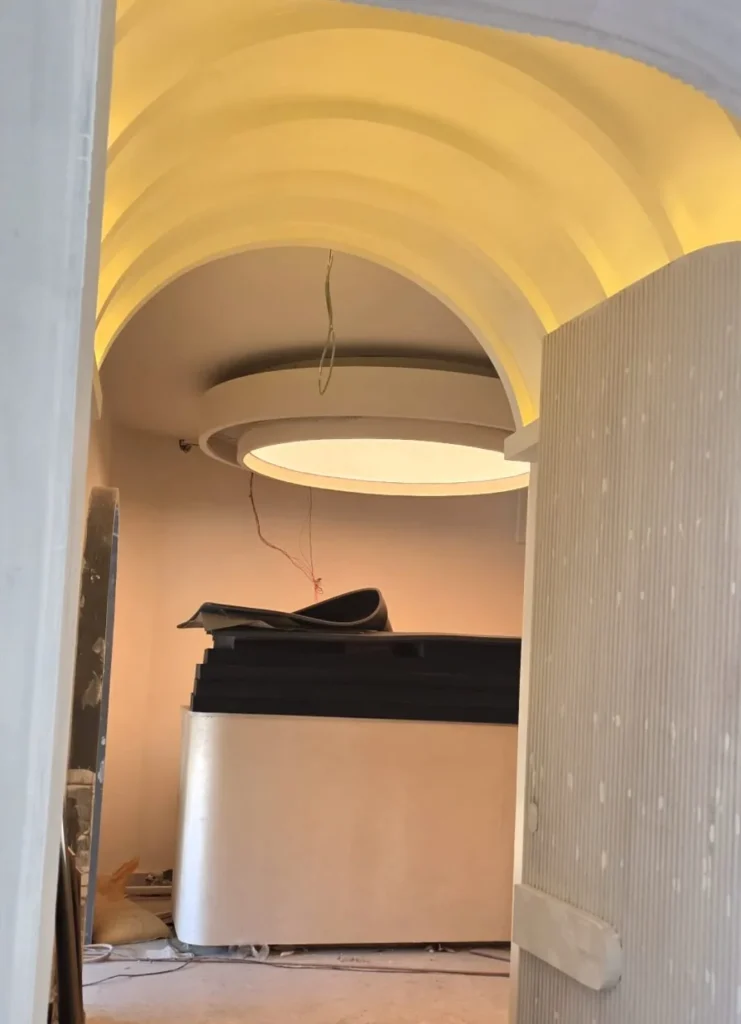 Finished composition of five oval and round white plain backlit stretch fabric ceilings glowing above the spa salon treatment and reception zones in Bahria Town Islamabad
