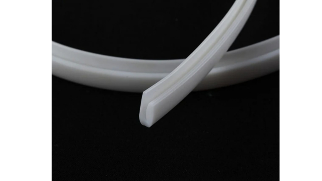 PVC harpoon wedge welded to stretch fabric edge for track locking