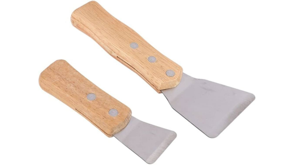 Stretch ceiling installation spatula tool pushing harpoon into aluminium track