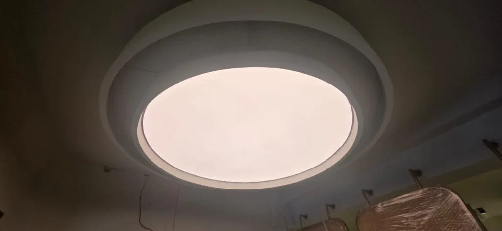 oval and round white plain backlit stretch fabric ceilings glowing above the spa salon treatment and reception zones in Bahria Town Islamabad