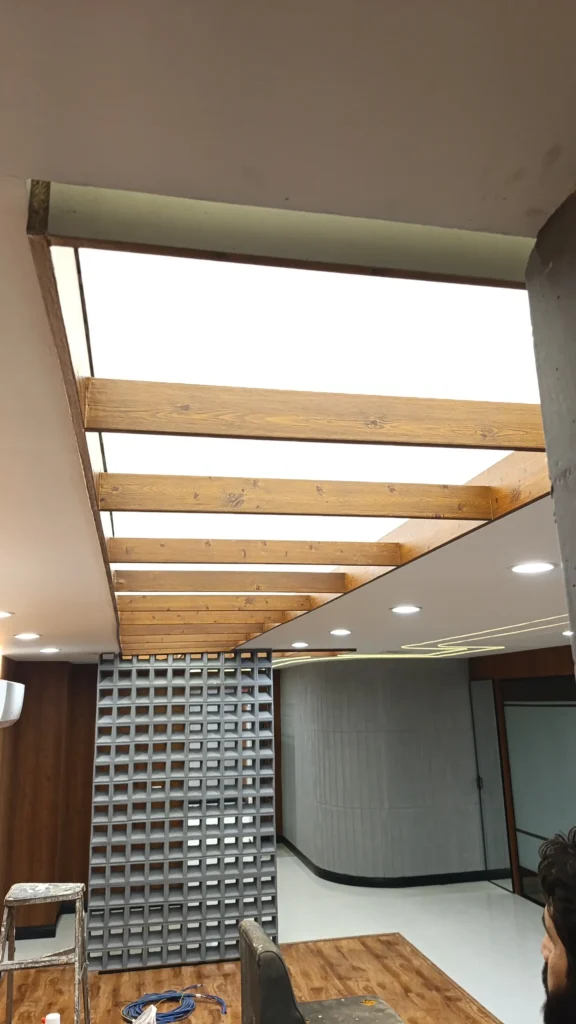 Premium translucent stretch membrane ceiling behind wooden beams in office room, Evacuee Trust Complex Islamabad